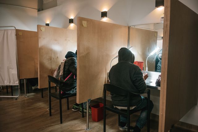Clients use drugs at supervised booths in the overdose prevention center in Harlem. Mirrors make it easier for staff to keep an eye on the clients in case they need overdose treatment.